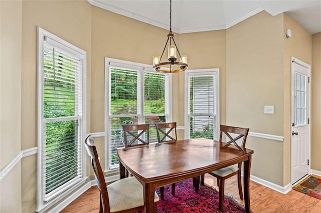 2709 Windrush Dr, Buford, GA 30518 - dining area featuring baseboards, light wood finished floors, a chandelier, and crown molding