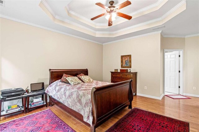 2709 Windrush Dr, Buford, GA 30518 - bedroom with a tray ceiling, wood finished floors, crown molding, baseboards, and ceiling fan