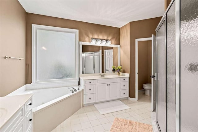 2709 Windrush Dr, Buford, GA 30518 - bathroom with a shower stall, vanity, a garden tub, tile patterned floors, and toilet