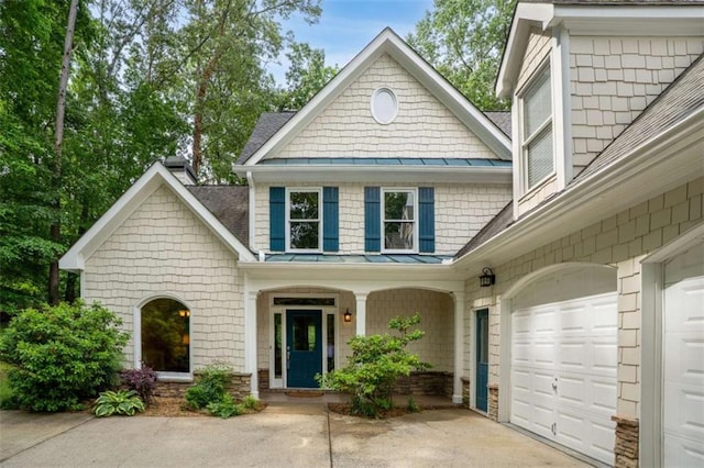2709 Windrush Dr, Buford, GA 30518 - view of front facade with a standing seam roof, a garage, driveway, metal roof, and a shingled roof