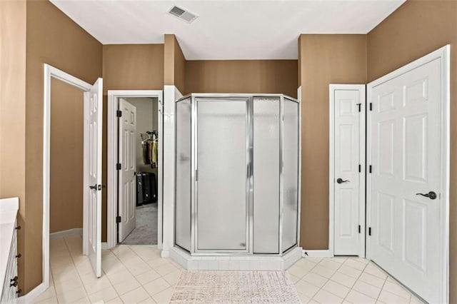 2709 Windrush Dr, Buford, GA 30518 - full bath with tile patterned flooring, a shower stall, baseboards, vanity, and a closet