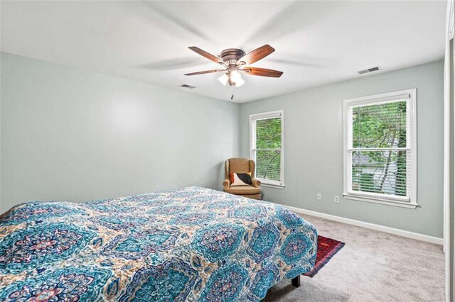 2709 Windrush Dr, Buford, GA 30518 - carpeted bedroom with baseboards and ceiling fan