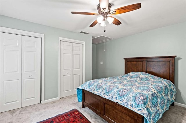 2709 Windrush Dr, Buford, GA 30518 - bedroom with light carpet, attic access, two closets, baseboards, and ceiling fan