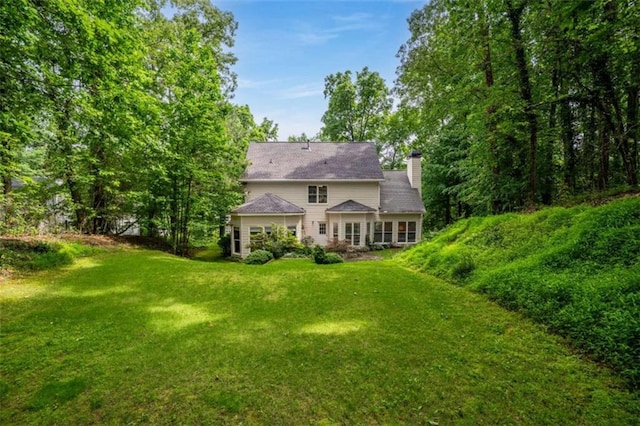 2709 Windrush Dr, Buford, GA 30518 - rear view of house featuring a lawn and a chimney