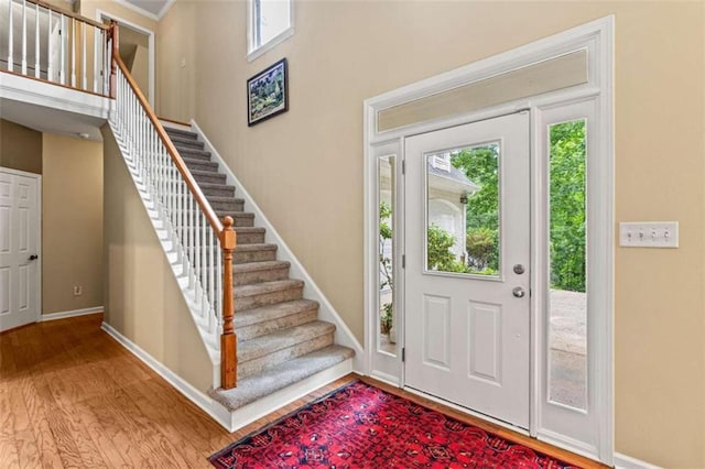 2709 Windrush Dr, Buford, GA 30518 - entrance foyer with wood finished floors, stairway, and baseboards