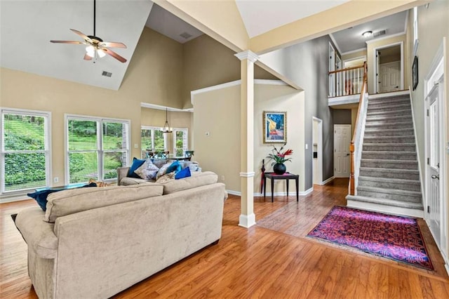 2709 Windrush Dr, Buford, GA 30518 - living room featuring high vaulted ceiling, ceiling fan, wood finished floors, baseboards, and stairway