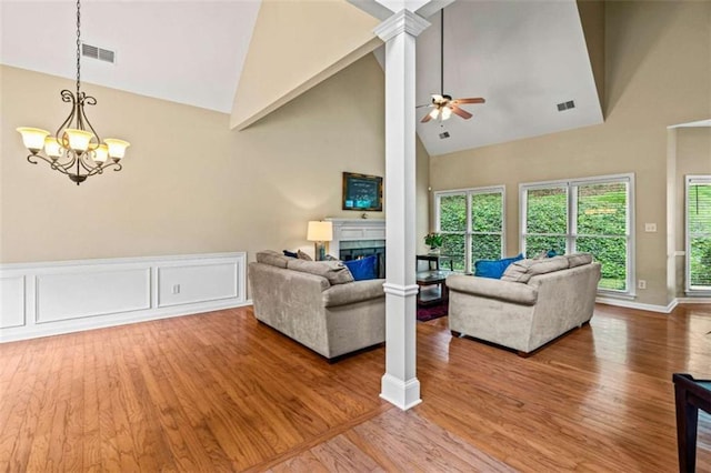 2709 Windrush Dr, Buford, GA 30518 - living area with high vaulted ceiling, a fireplace, a chandelier, wood finished floors, and ceiling fan