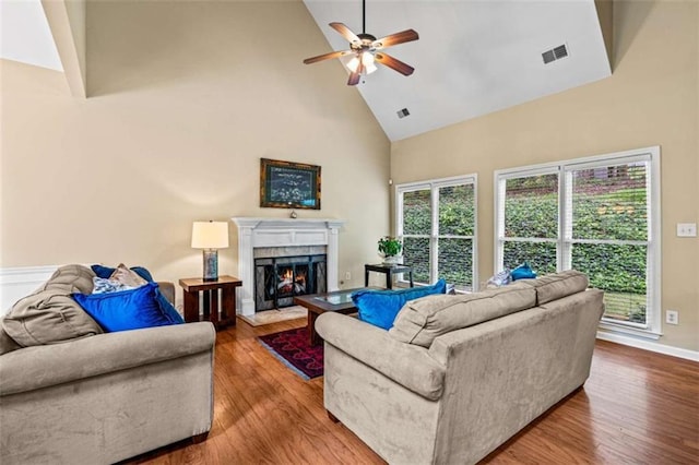 2709 Windrush Dr, Buford, GA 30518 - living area with high vaulted ceiling, ceiling fan, wood finished floors, a premium fireplace, and baseboards