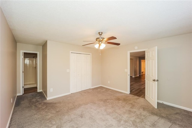 unfurnished bedroom featuring ceiling fan, a closet, and carpet