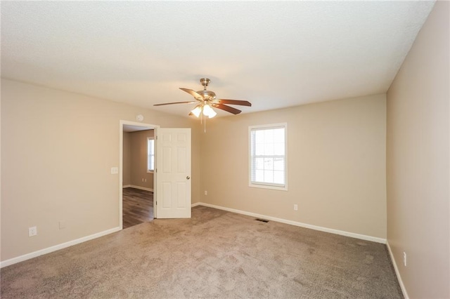 empty room featuring ceiling fan and carpet floors