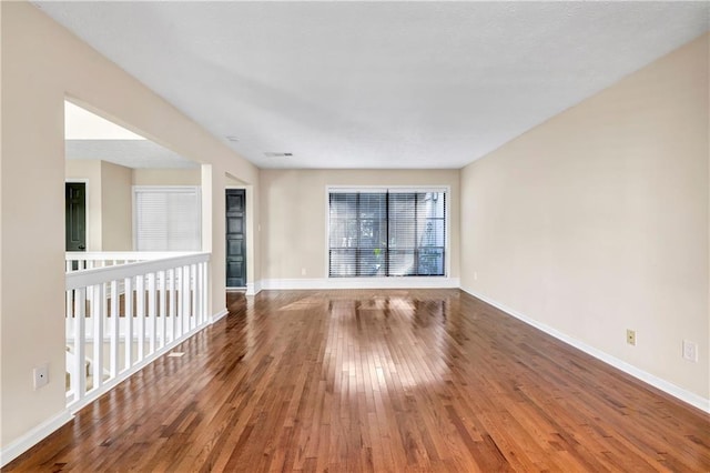 empty room with hardwood / wood-style floors