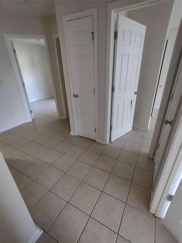 corridor with light tile patterned floors