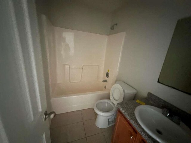 full bathroom featuring tile patterned flooring, vanity, toilet, and washtub / shower combination