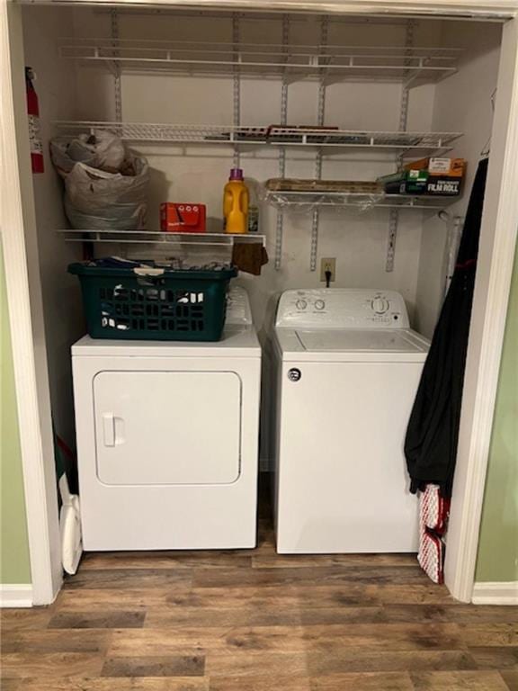 washroom featuring separate washer and dryer and wood-type flooring