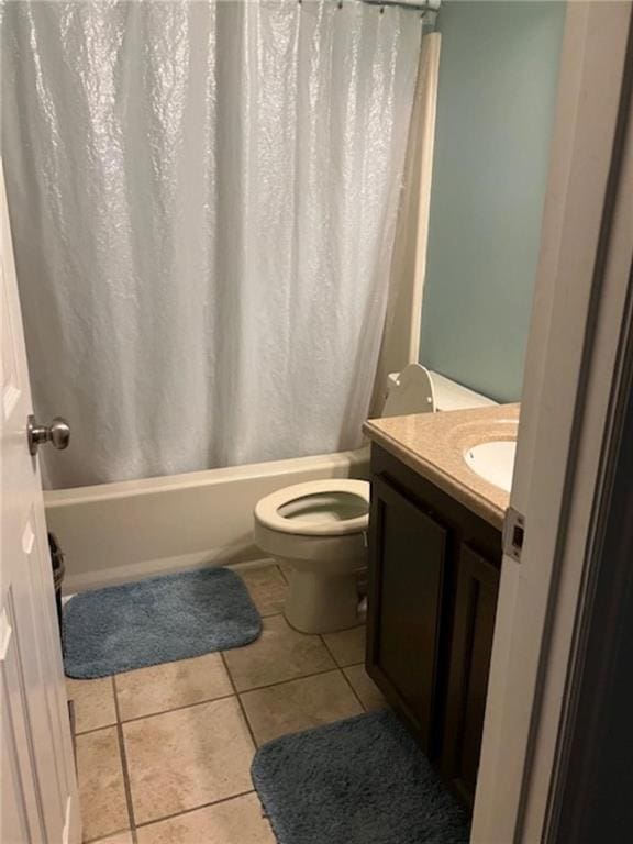 full bathroom featuring toilet, tile patterned floors, shower / bathtub combination with curtain, and vanity