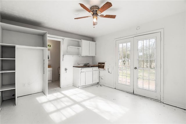 kitchen featuring white cabinetry, ceiling fan, and french doors