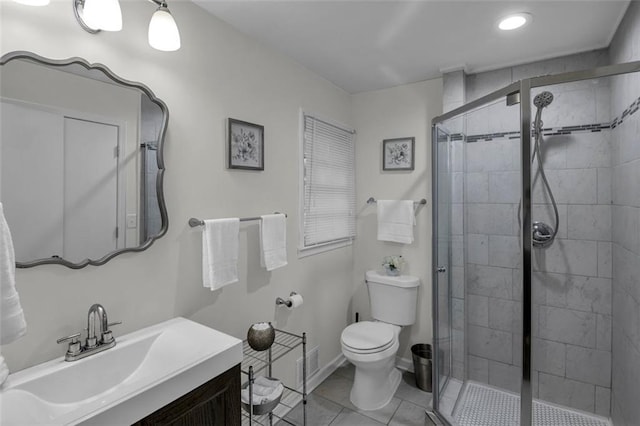 bathroom with tile patterned flooring, vanity, toilet, and a shower with door