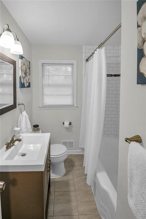 full bathroom featuring tile patterned floors, shower / tub combo with curtain, vanity, and toilet