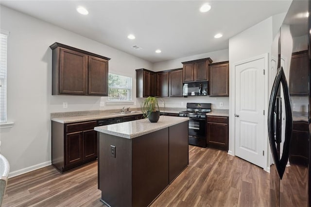 81 Birch River Pointe, Dallas, GA 30132 - kitchen with black appliances, a sink, dark brown cabinetry, dark wood-style flooring, and recessed lighting