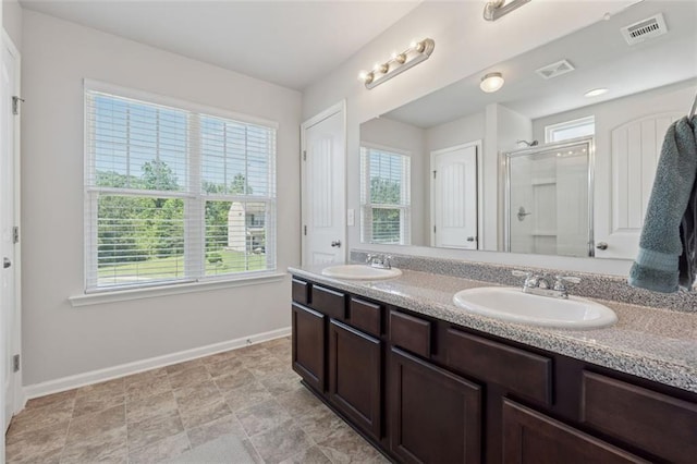 81 Birch River Pointe, Dallas, GA 30132 - full bath with healthy amount of natural light, baseboards, a shower stall, and double vanity