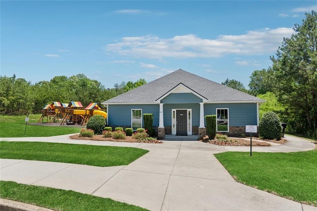 81 Birch River Pointe, Dallas, GA 30132 - view of front of home featuring a playground, a front lawn, stone siding, and a shingled roof