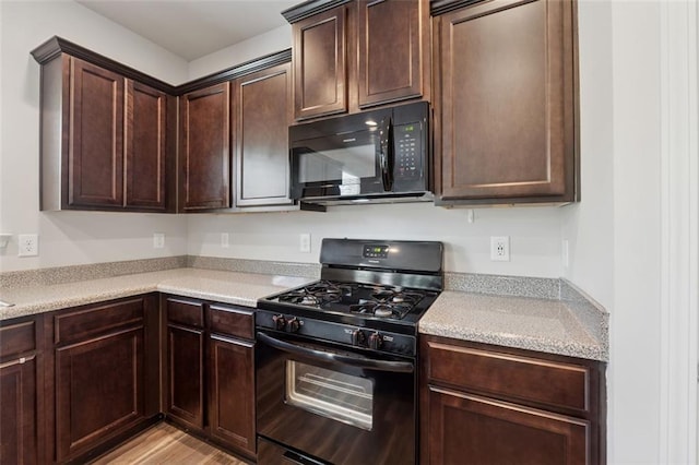 81 Birch River Pointe, Dallas, GA 30132 - kitchen featuring black appliances, dark brown cabinets, and light countertops