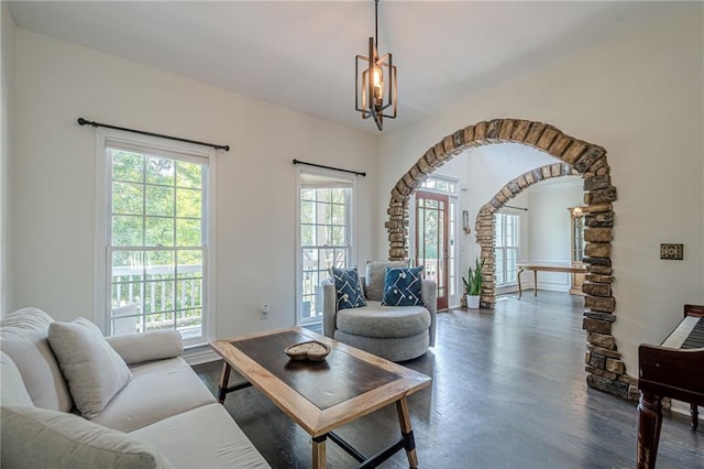 113 Gold Bridge Xing, Canton, GA 30114 - living area featuring dark wood-type flooring, arched walkways, and a chandelier