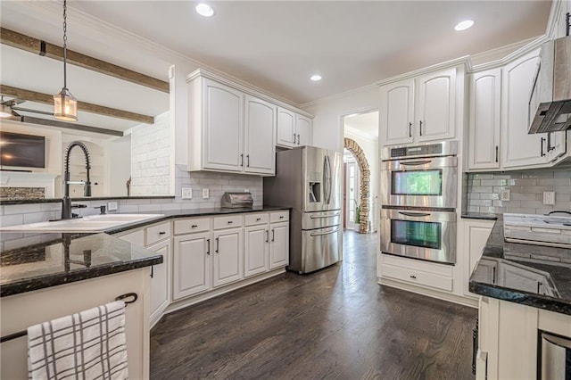 113 Gold Bridge Xing, Canton, GA 30114 - kitchen featuring appliances with stainless steel finishes, dark stone counters, pendant lighting, a sink, and backsplash