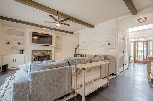 113 Gold Bridge Xing, Canton, GA 30114 - living room featuring ceiling fan, beam ceiling, a fireplace, dark wood-style flooring, and built in shelves