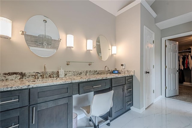 113 Gold Bridge Xing, Canton, GA 30114 - bathroom featuring baseboards, vaulted ceiling, double vanity, marble finish floors, and a walk in closet