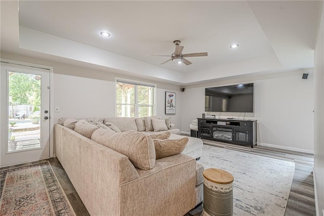 113 Gold Bridge Xing, Canton, GA 30114 - living room featuring a raised ceiling, ceiling fan, wood finished floors, baseboards, and recessed lighting