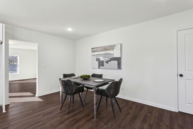 dining space with baseboards, dark wood-type flooring, and recessed lighting