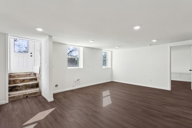 below grade area featuring stairway, recessed lighting, dark wood finished floors, and baseboards