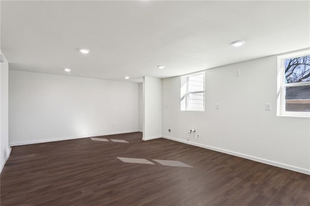 spare room featuring baseboards, wood finished floors, and recessed lighting