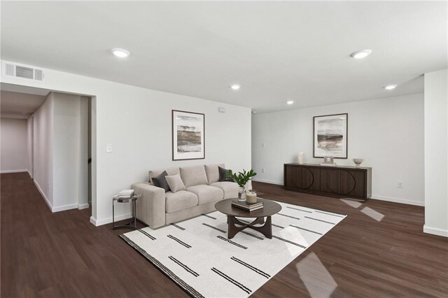 living area featuring recessed lighting, visible vents, baseboards, and wood finished floors