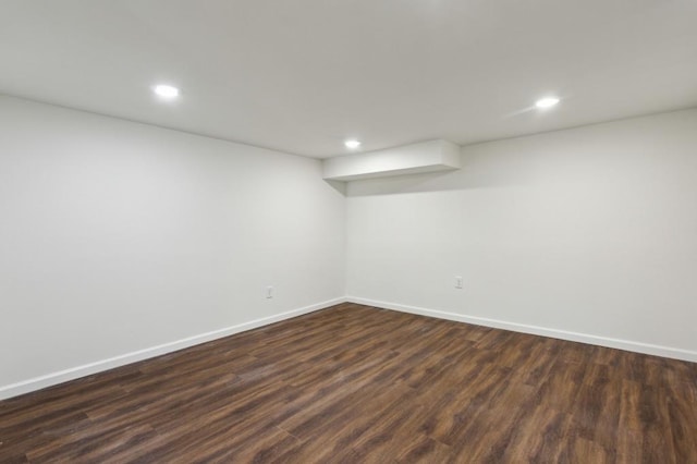 finished below grade area with recessed lighting, dark wood-style flooring, and baseboards