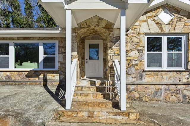 doorway to property with stone siding