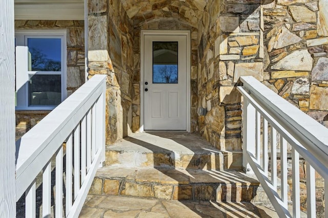 entrance to property featuring stone siding