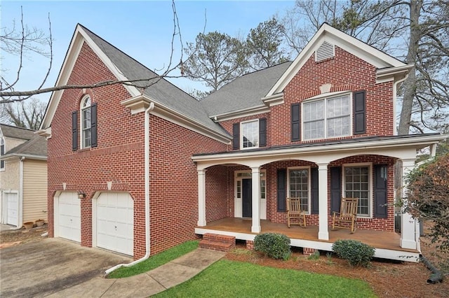 view of property featuring a garage and covered porch