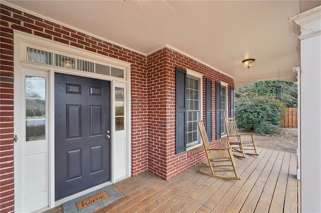 view of exterior entry with a porch