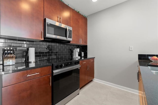 kitchen with electric stove, light tile patterned floors, decorative backsplash, and dark stone countertops