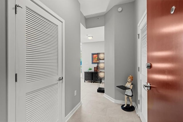 hallway featuring light tile patterned floors