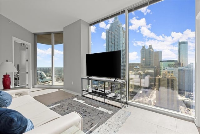 tiled living room featuring a wall of windows