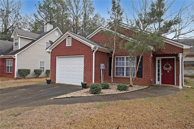 view of front of house featuring brick siding, driveway, a front lawn, and a garage