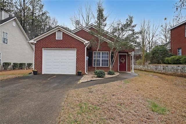 view of front of home with aphalt driveway, a garage, and brick siding