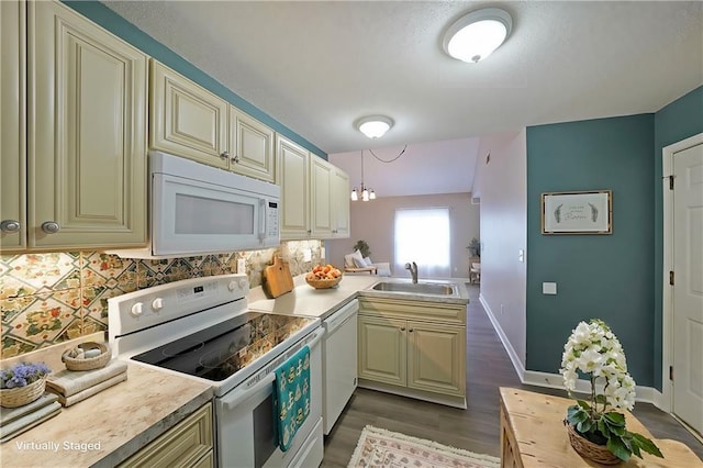 kitchen featuring tasteful backsplash, light countertops, cream cabinetry, white appliances, and a sink