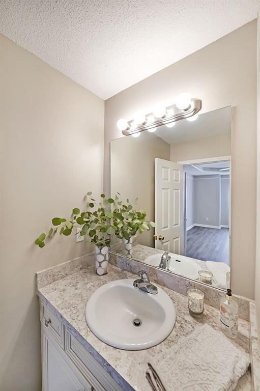 bathroom with a textured ceiling and vanity