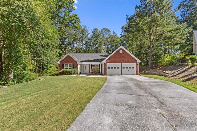 view of front of house featuring a garage and a front lawn