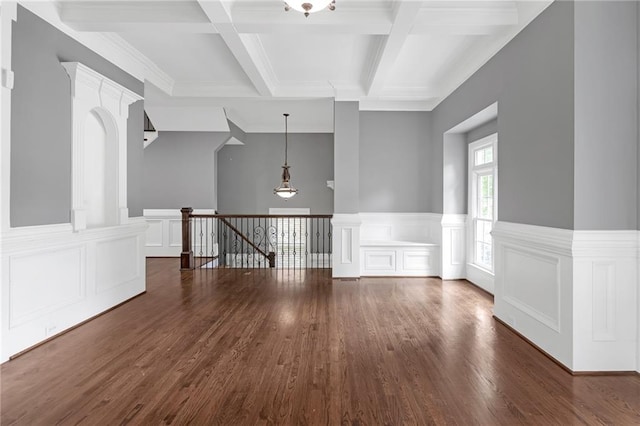 unfurnished room with coffered ceiling, dark hardwood / wood-style floors, and beamed ceiling