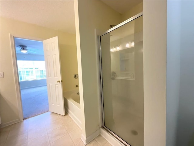 bathroom featuring a garden tub, baseboards, a shower stall, and tile patterned floors